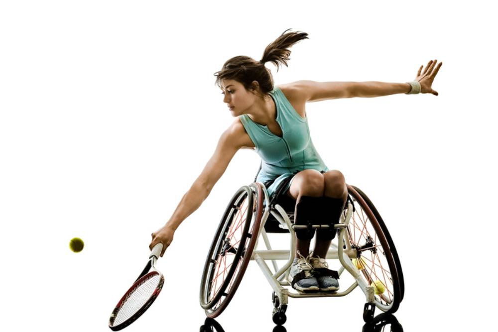 A women in a wheel chair playing tennis